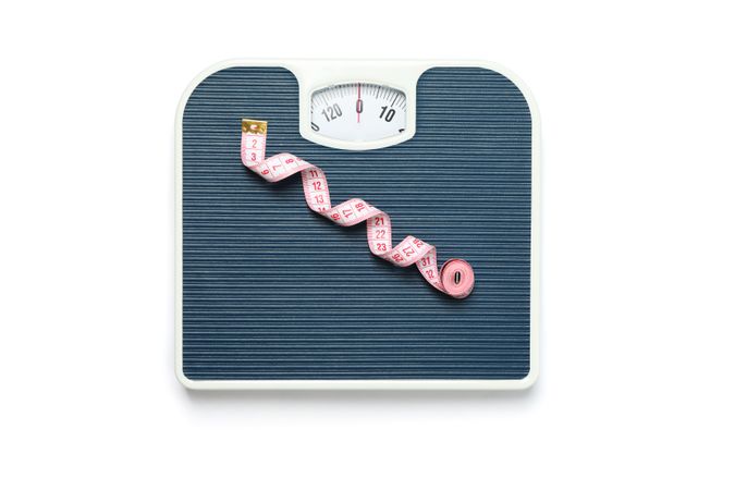 Weigh scales and measuring tape isolated on blank background