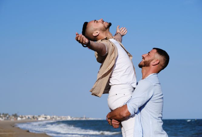 Happy gay couple enjoying and embracing outdoors