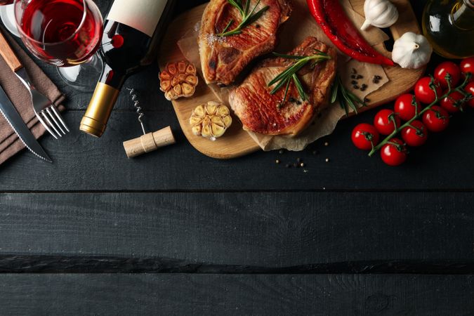Composition with fried steaks and wine. Grilled food