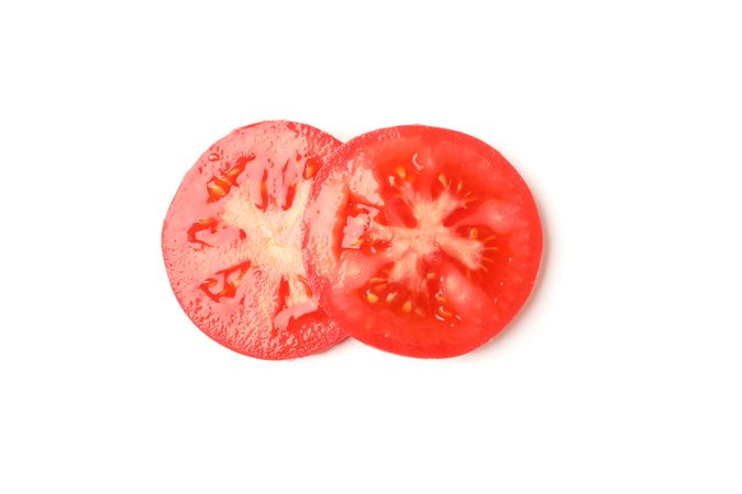 Slices of tasty tomato isolated on neutral background
