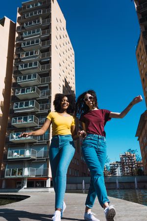 Two confident women walking in city