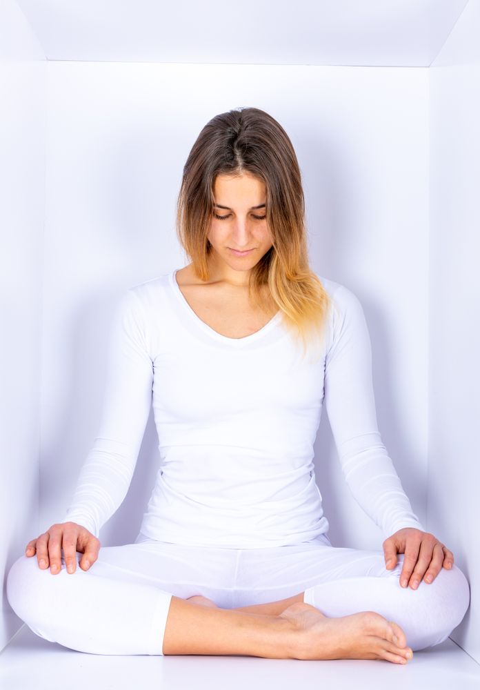 Woman wearing white posing in box