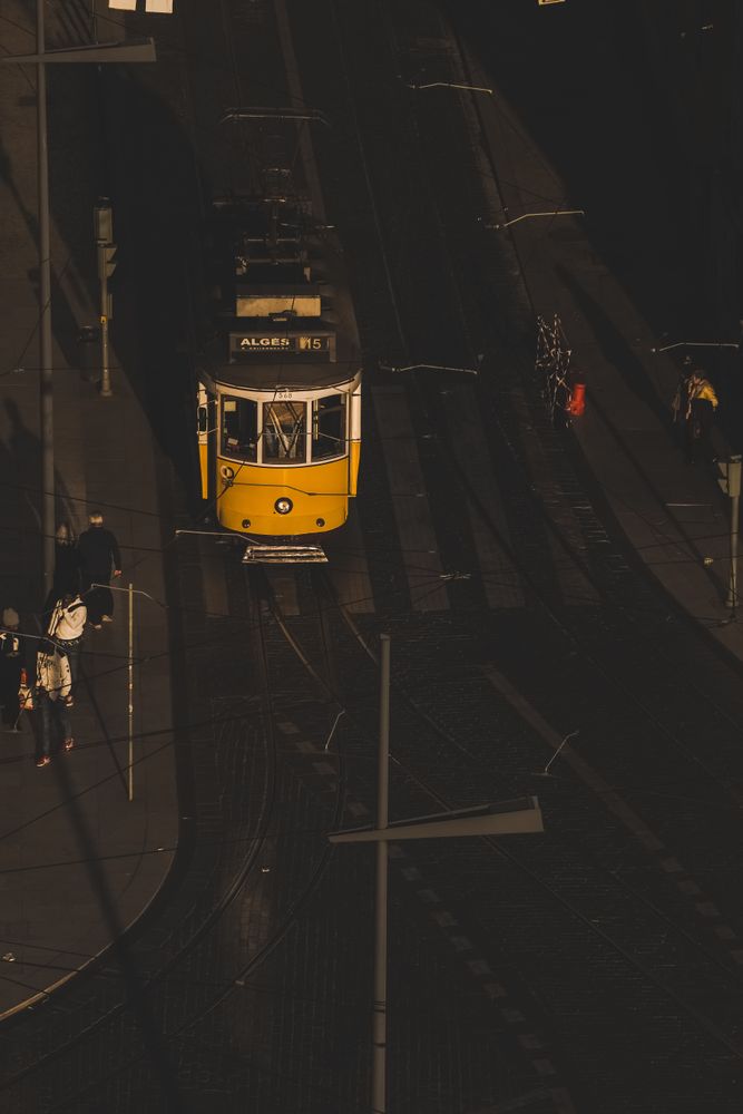 LISBON, PORTUGAL - JANUARY 23, 2019: Tramway on city street with pedestrians on sidewalk