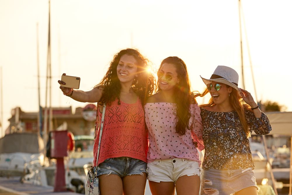 Optimistic fellows bonding and shooting selfie in summer