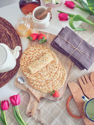 Delicious tasty homemade crepes on kitchen desk