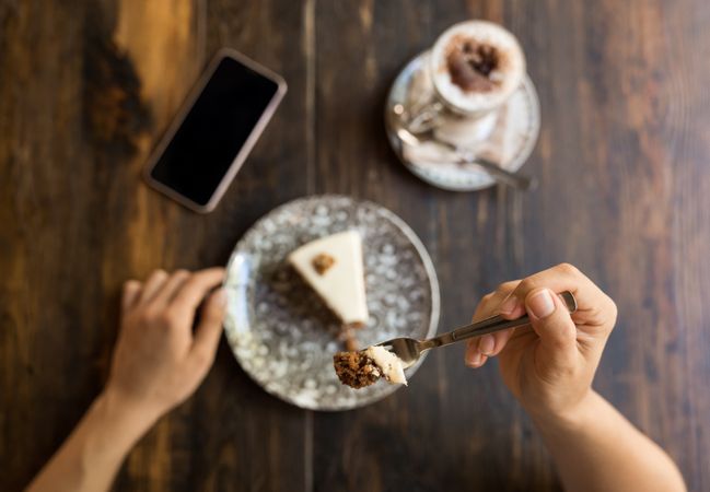 Woman eating cake in restaurant