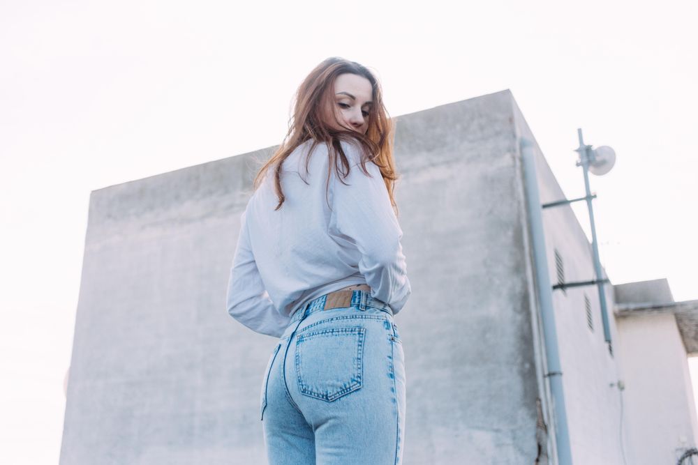Red haired woman turning back on roof