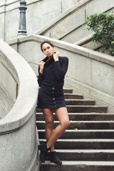 Portrait of confident woman in sweater outside standing on stairs