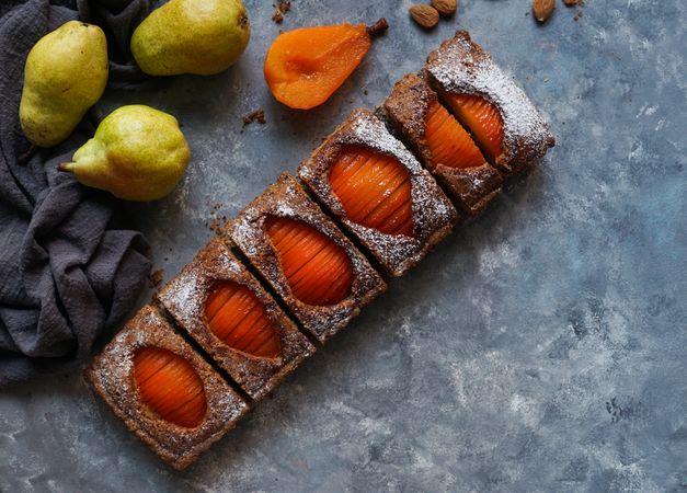 Pear cake and fruits on table