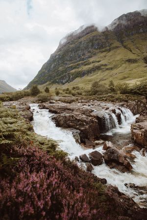 Mountain river with stones on daytime