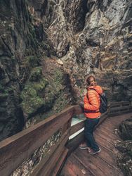 Traveller admiring picturesque view of mountain ridge