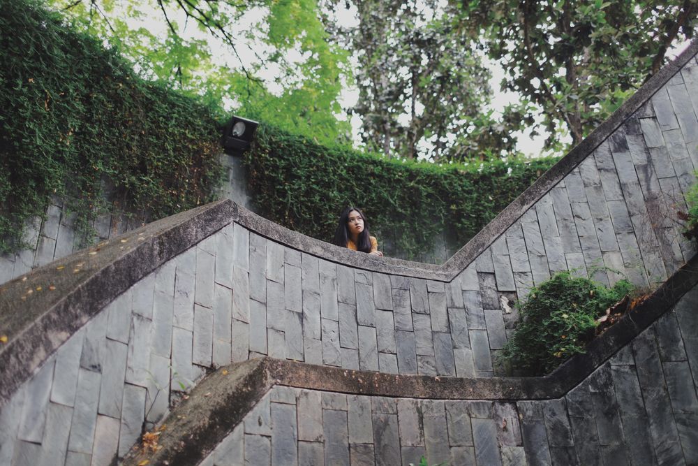 Woman standing on concrete bridge in nature