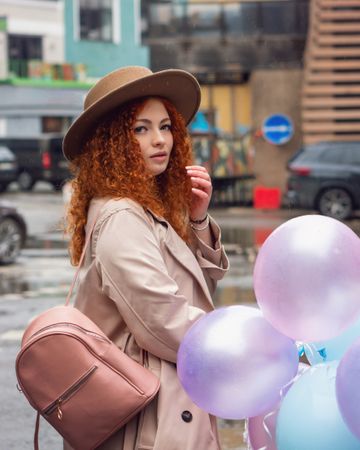 Woman walking outside with balloons