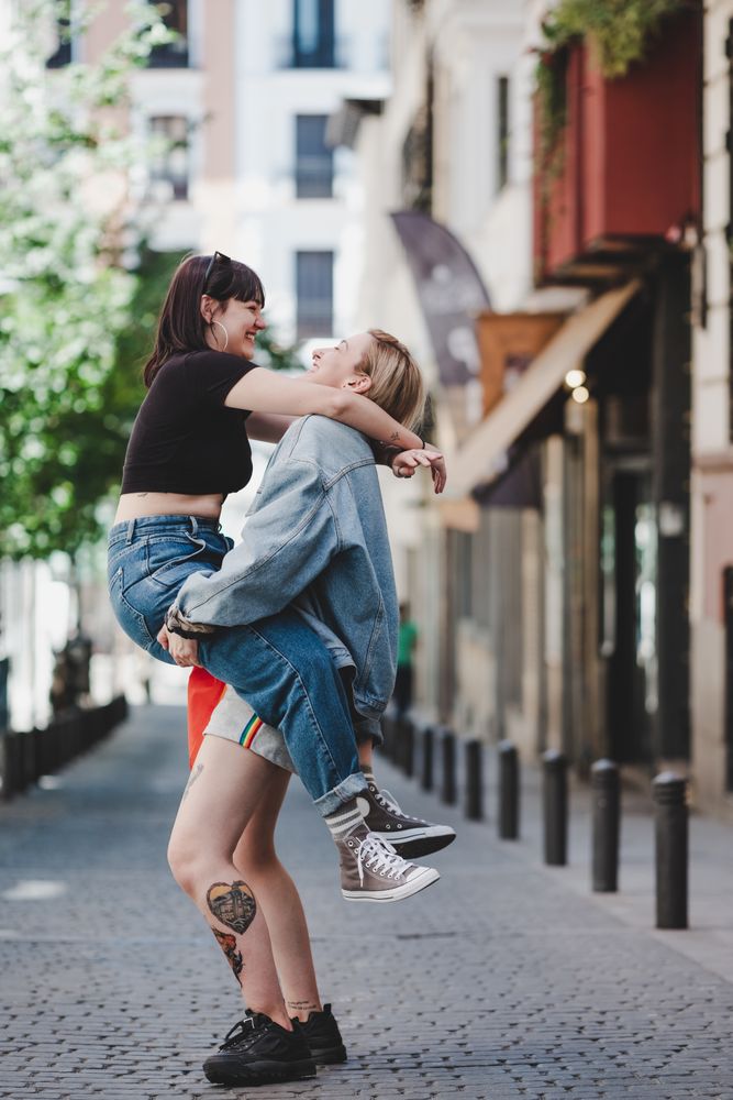 Happy lesbian couple having fun on street
