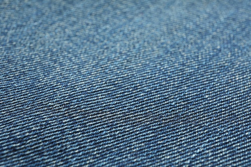 Texture of blue jeans as background, space for text