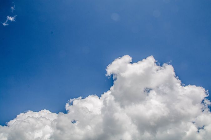 Fluffy clouds in clear blue sky