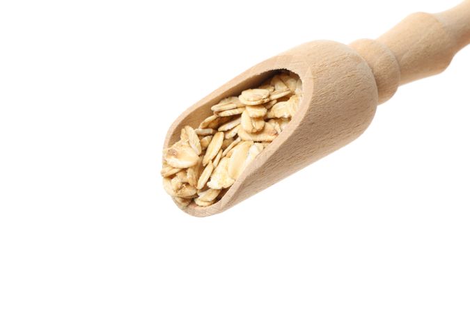 Scoop with oatmeal flakes isolated on plain background