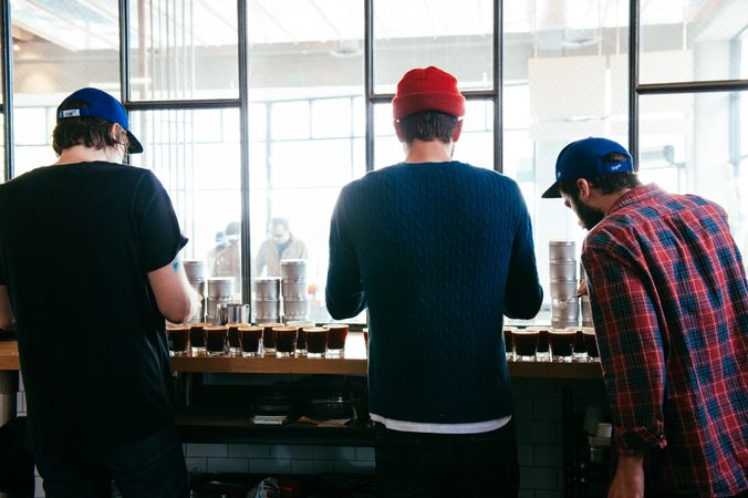 Back view of three men at coffee tasting