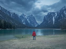 Male photographer near mountains and lake