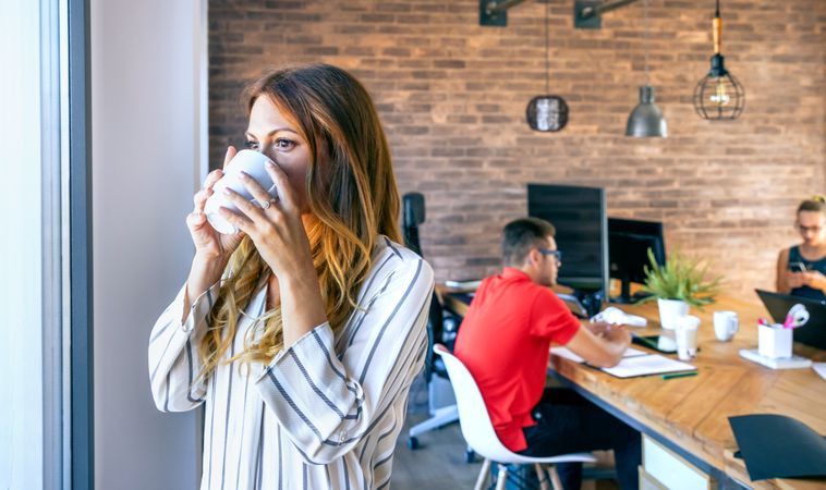 Businesswoman taking a coffee break in the office