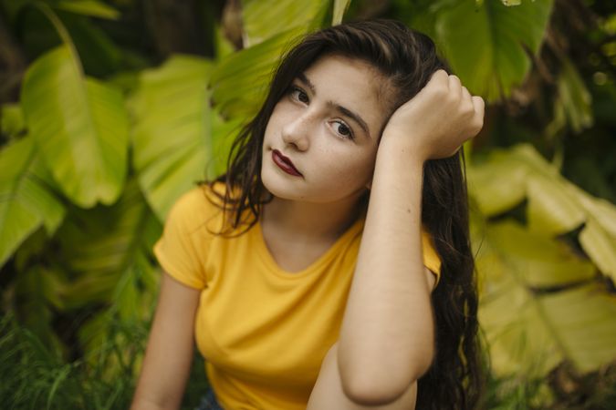 Dreamy female near tropical bush