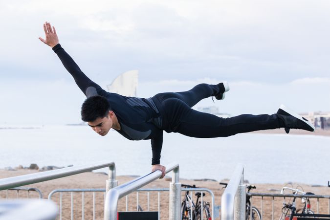 Athlete doing exercise on parallel bars