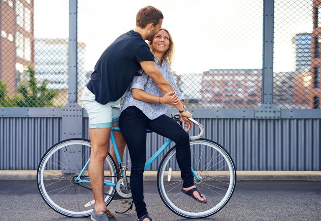 Cute couple embracing on a bike
