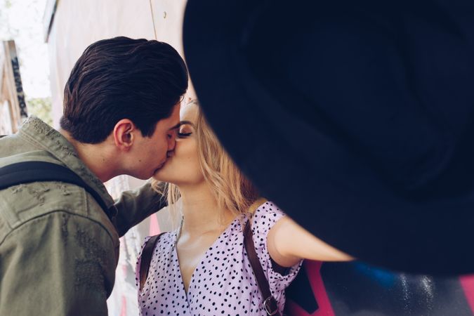 Happy couple kissing while walking in town