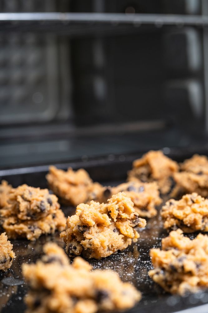 Chocolate chip cookies baking inside an oven