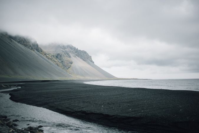 Dark sand beach on overcast day in Iceland