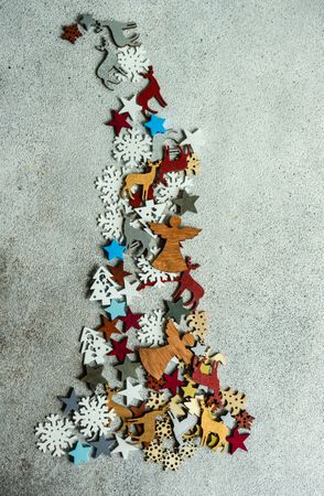 Flat Christmas ornaments in tree shape on concrete background