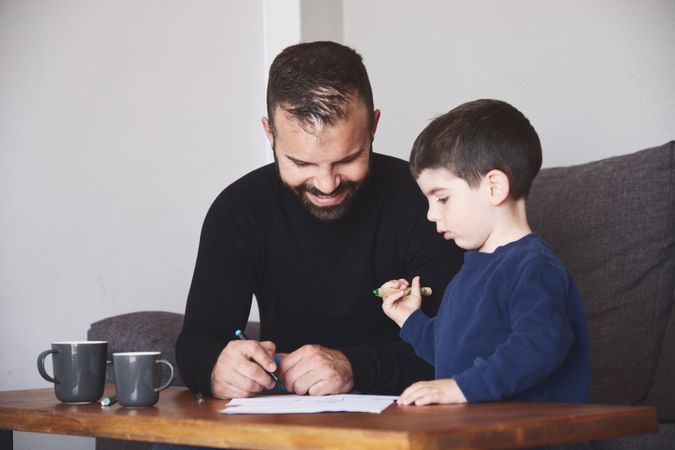 Father and son drawing together