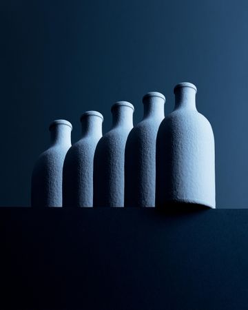 Five bottles over dark background