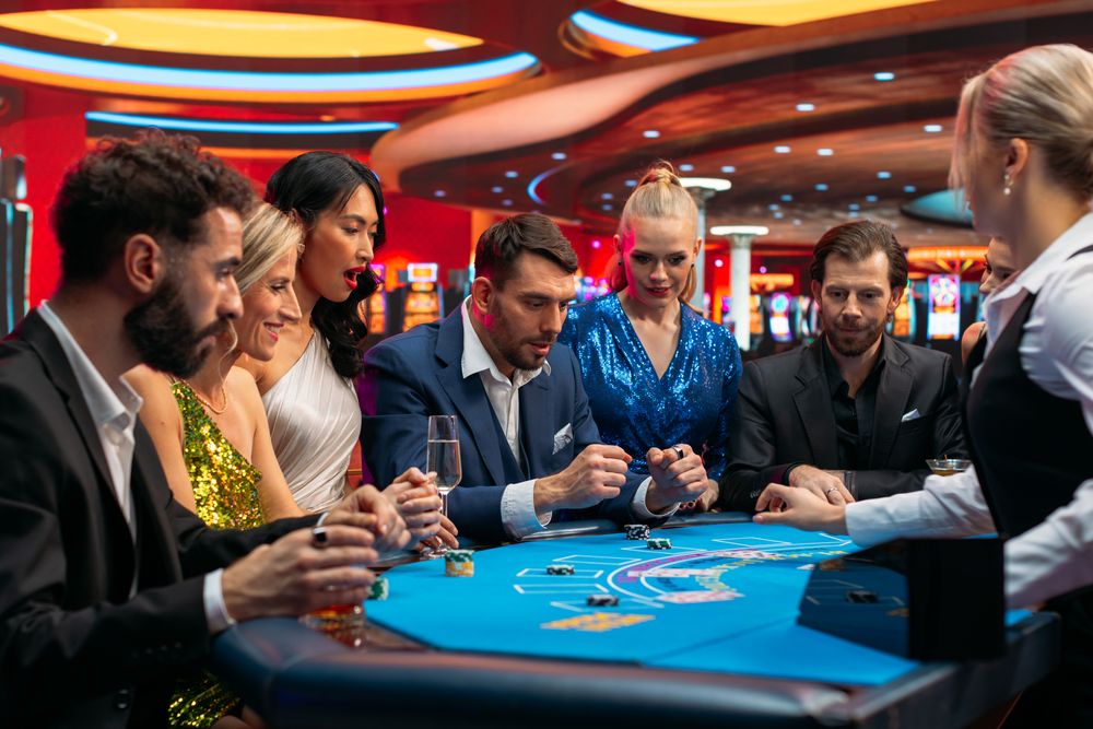 Cheerful Group of Rich People Gathered Around a Blackjack Table at a Casino.