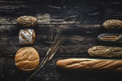 Assorted gold homemade bread on dark wood background