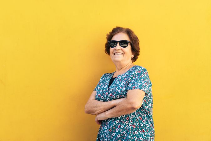 Stylish older woman in sunglasses and colorful clothes
