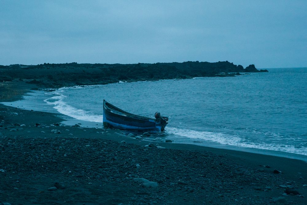 Small motor boat moored on Lanzarote beach in early evening