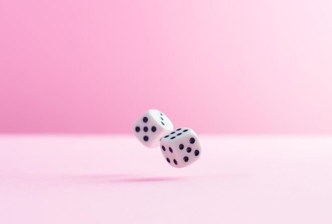 Two dice over pink background