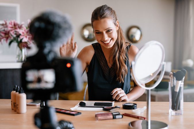 Woman making a video for her blog on cosmetics