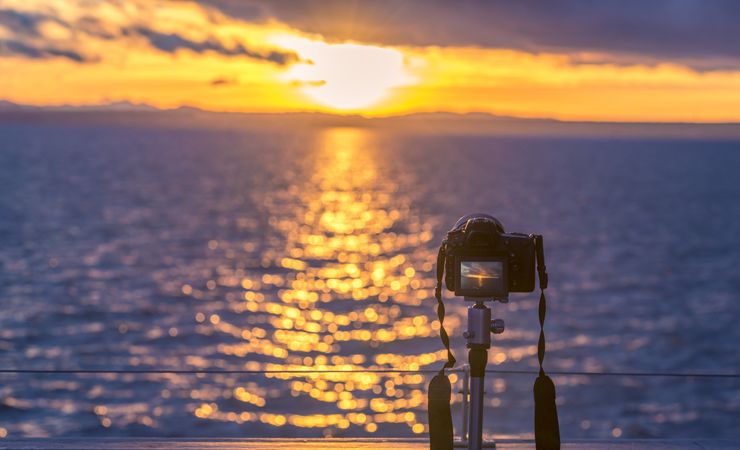 Sunset over water and a DSLR camera