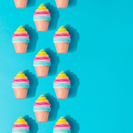 Pattern of colorful rows of ice cream on bright blue background