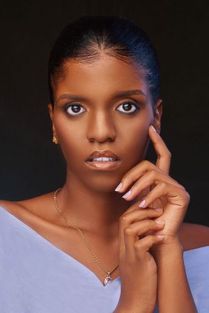 Portrait of young woman in light top