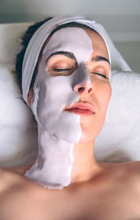 Woman resting with eyes closed with half a face mask