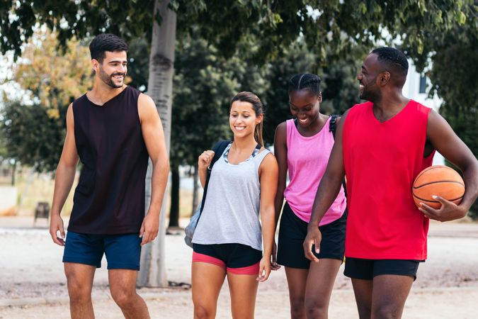 Group of multi-ethnic friends on their way to play basketball