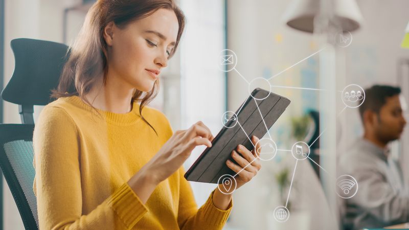 Virtual Connection Visualization Concept: Happy Young Woman Uses Digital Tablet Computer in the Office. Infographics Illustrate Cloud Computing,