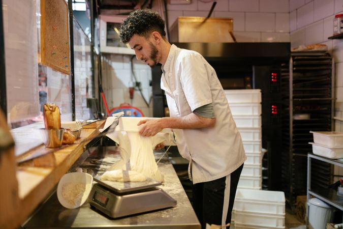 Pizza man taking dough out of a box