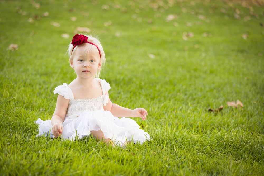 Girl Wearing White Dress In A Grass Field