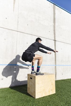 Man training on sports ground near wall