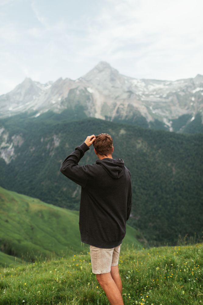Anonymous male admiring view of mountain ridge