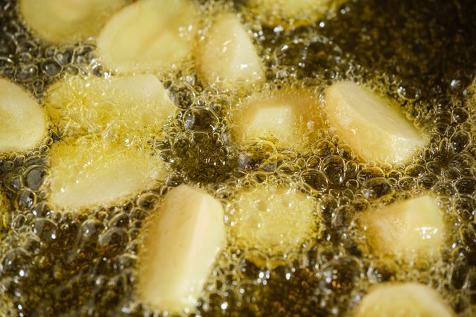Closeup of potato in boiling oil